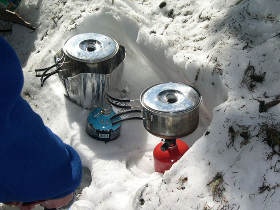 Heavy kitchen. Only one backup stove is needed. MSR at left is shielded and is used to boil water for food and drinks.