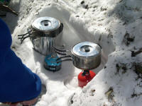 Heavy kitchen. Only one backup stove is needed. MSR at left is shielded and is used to boil water for food and drinks.